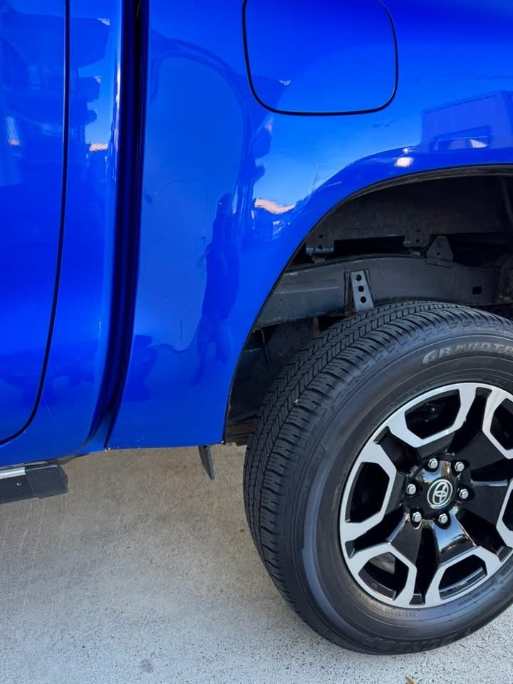 Closer view of the blue Toyota ute repaired rear quarter panel near the wheel arch