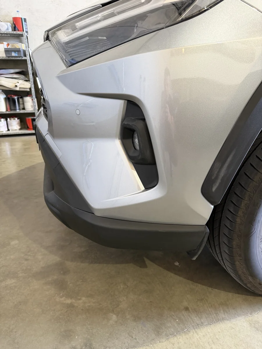 The silver bumper corner after repair, showing the finished appearance