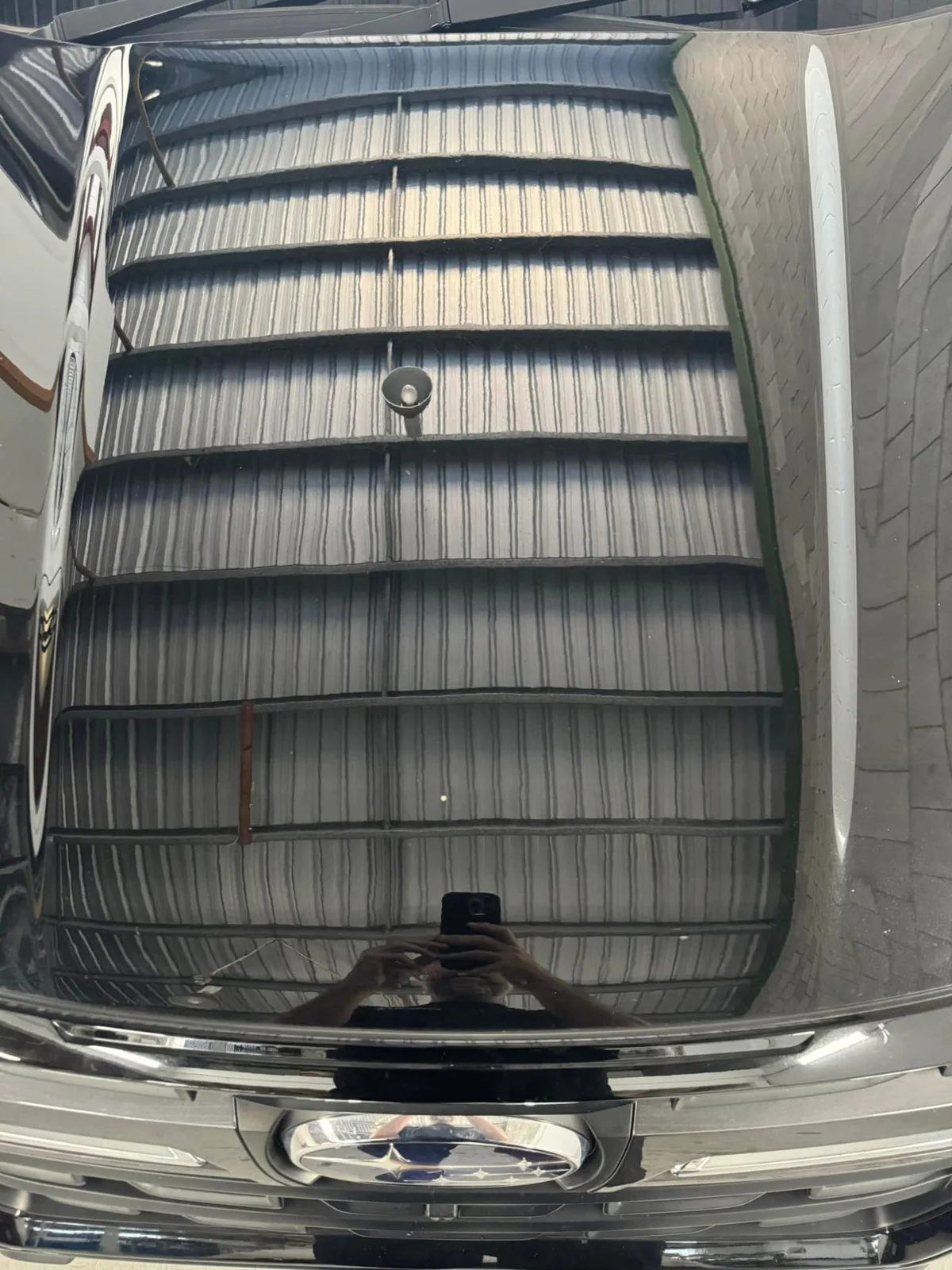 After repair: dark Subaru bonnet centre view showing its finished appearance