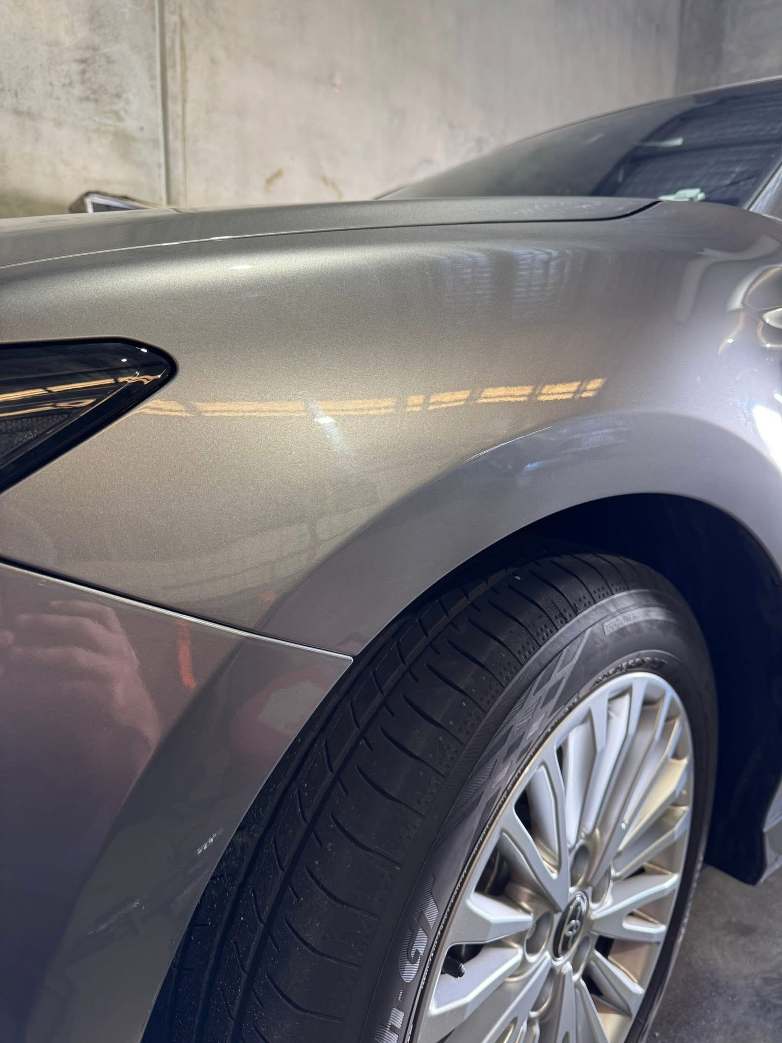 After repair: the same grey Toyota front fender showing its finished appearance