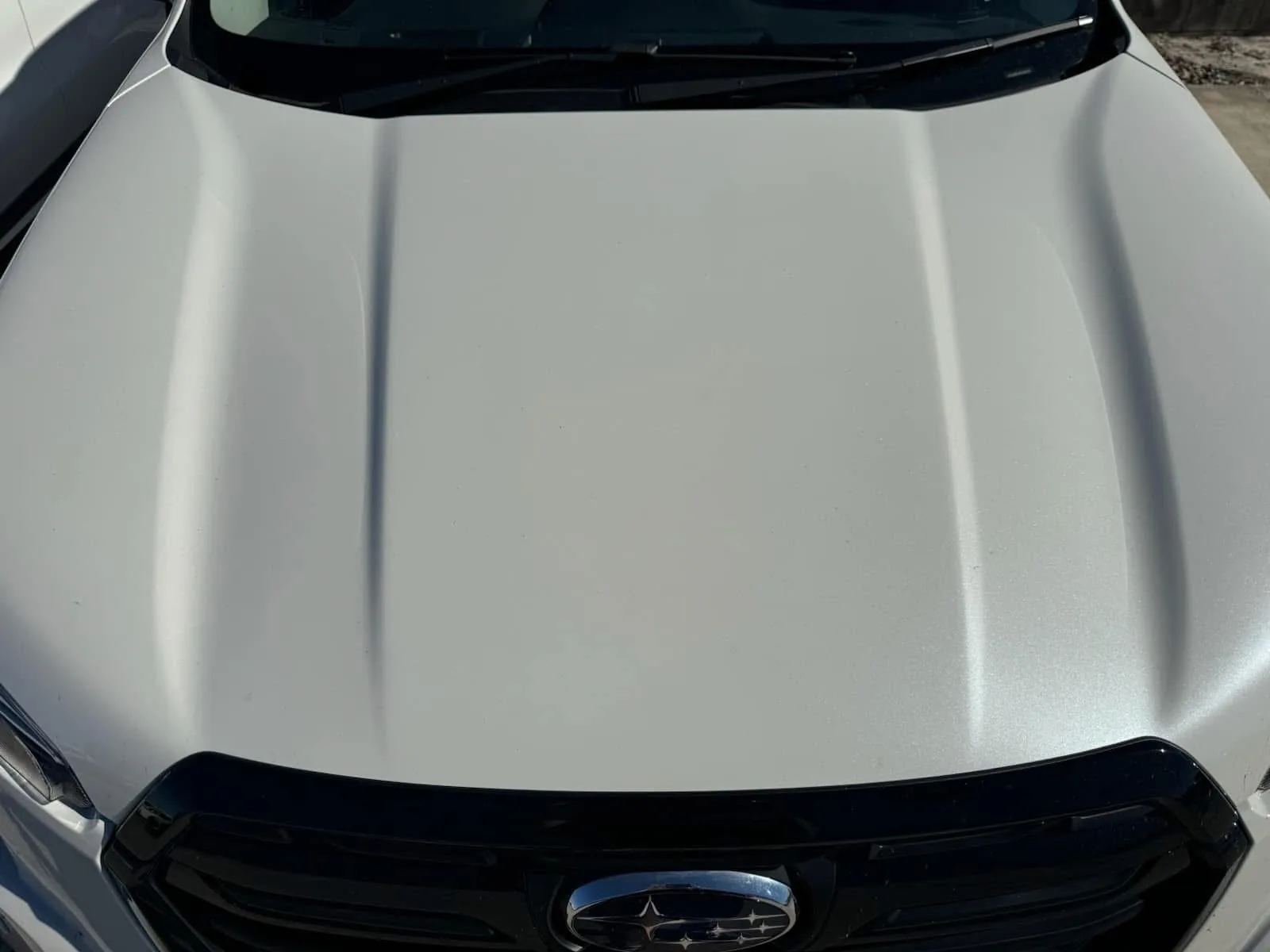 After repair: the white Subaru bonnet showing its finished appearance