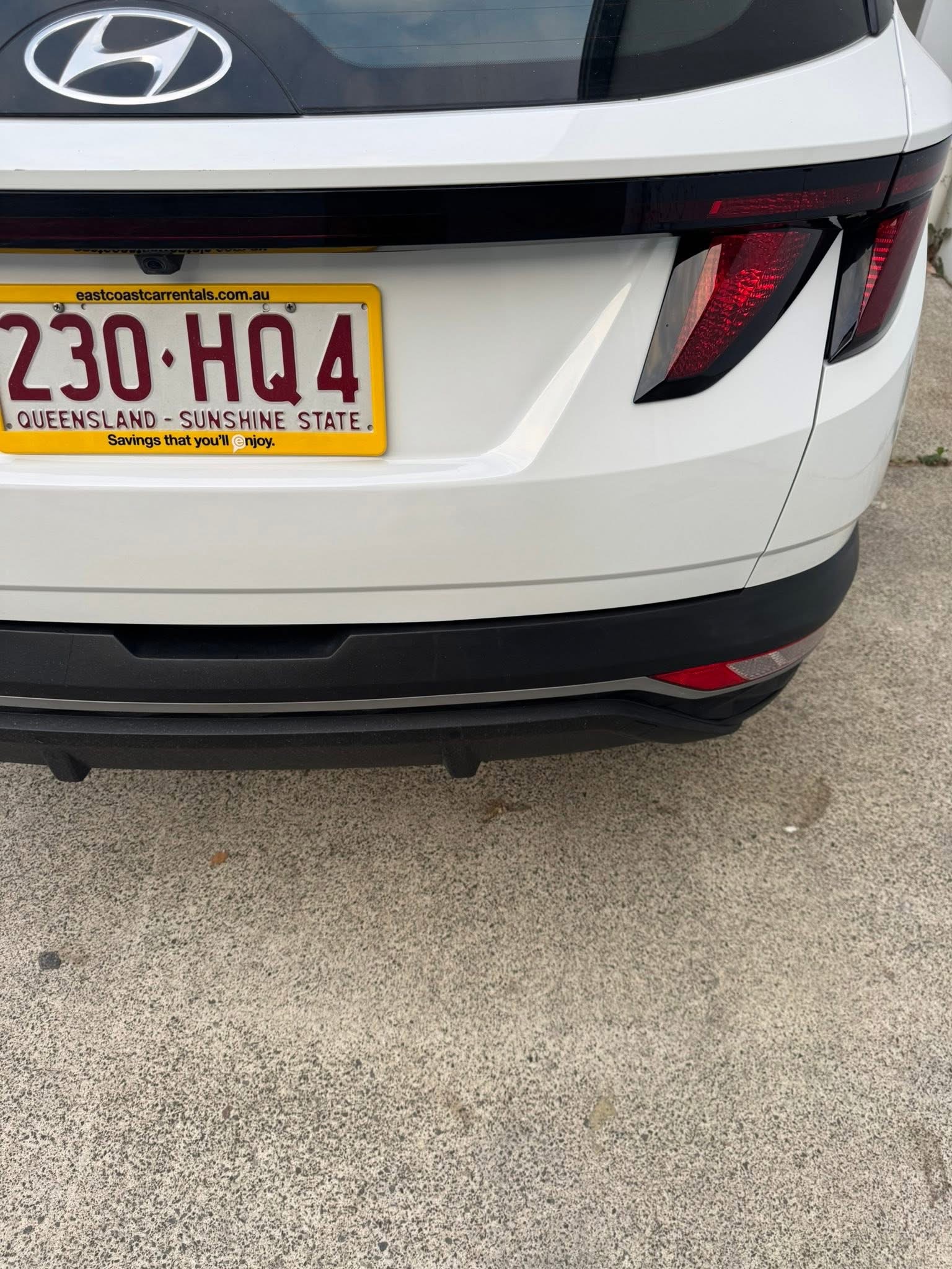 After repair: finished white Hyundai rear hatch photographed from a wider angle